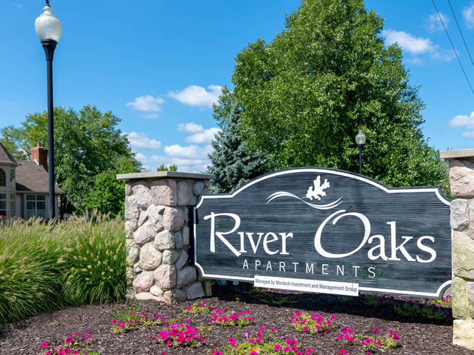 Welcome sign for River Oaks Apartments