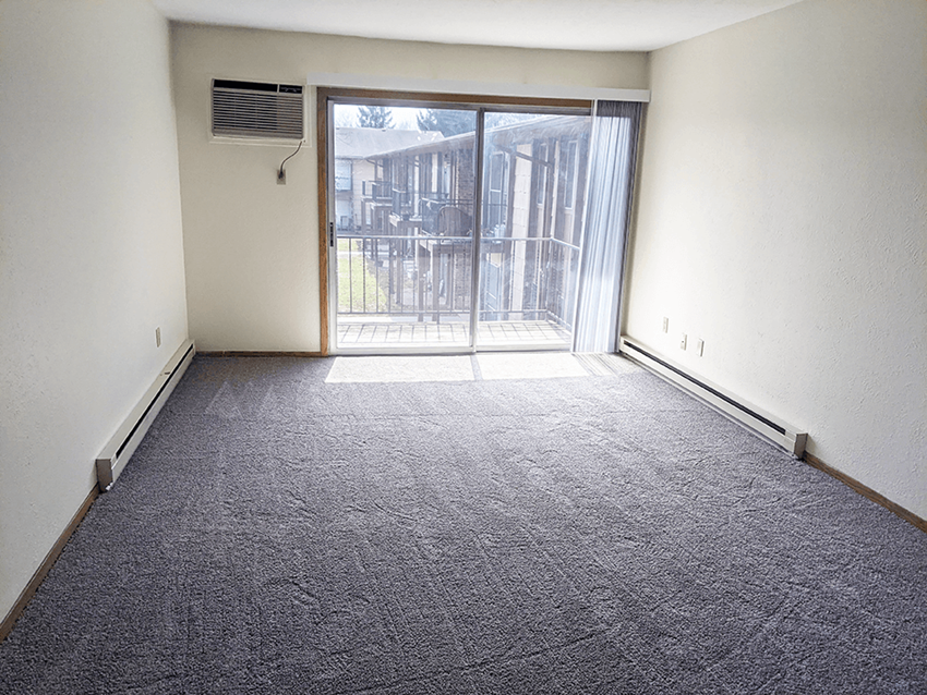living room windows at Whispering Timbers Apartments