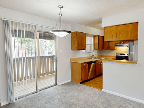 A kitchen with wooden cabinets and a dishwasher.
