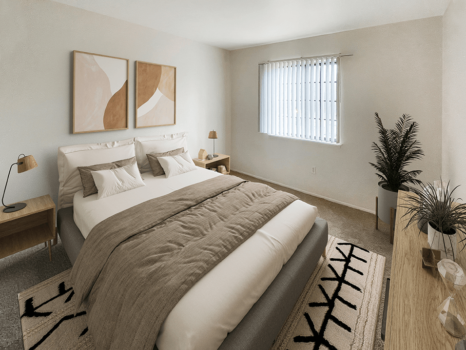 a bedroom with a large bed and a window