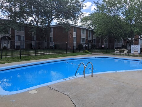a swimming pool in front of an apartment building