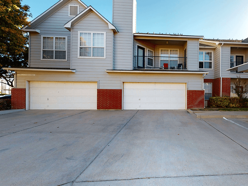 a car garage in front of an apartment