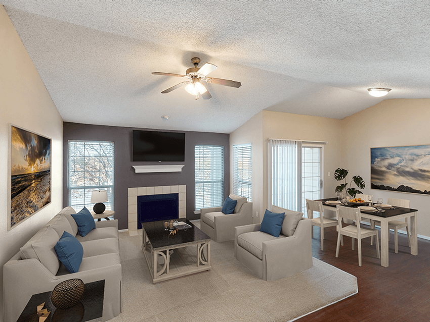 a living room with a fireplace and a ceiling fan - Photo Gallery 1