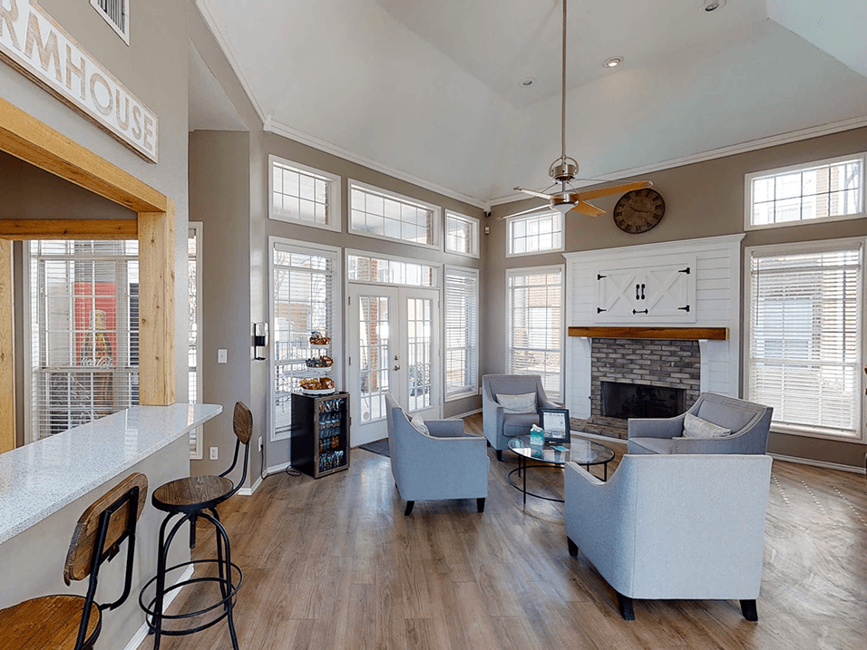 a living room with large windows and a fireplace