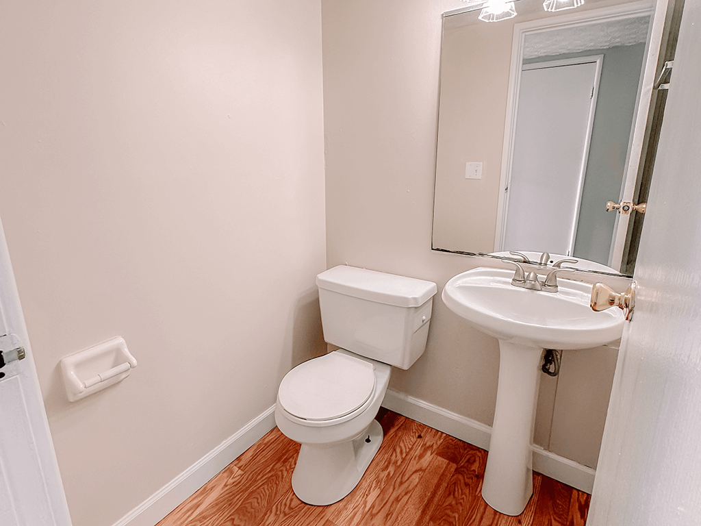 an empty bathroom with a toilet and a sink