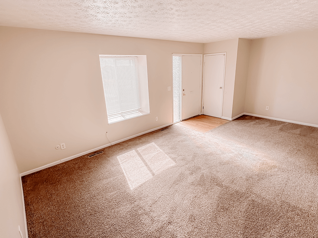 apartment living room with carpet and air conditioning