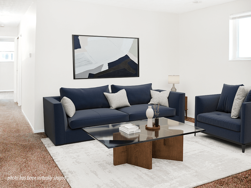 A living room with a blue couch and a coffee table.