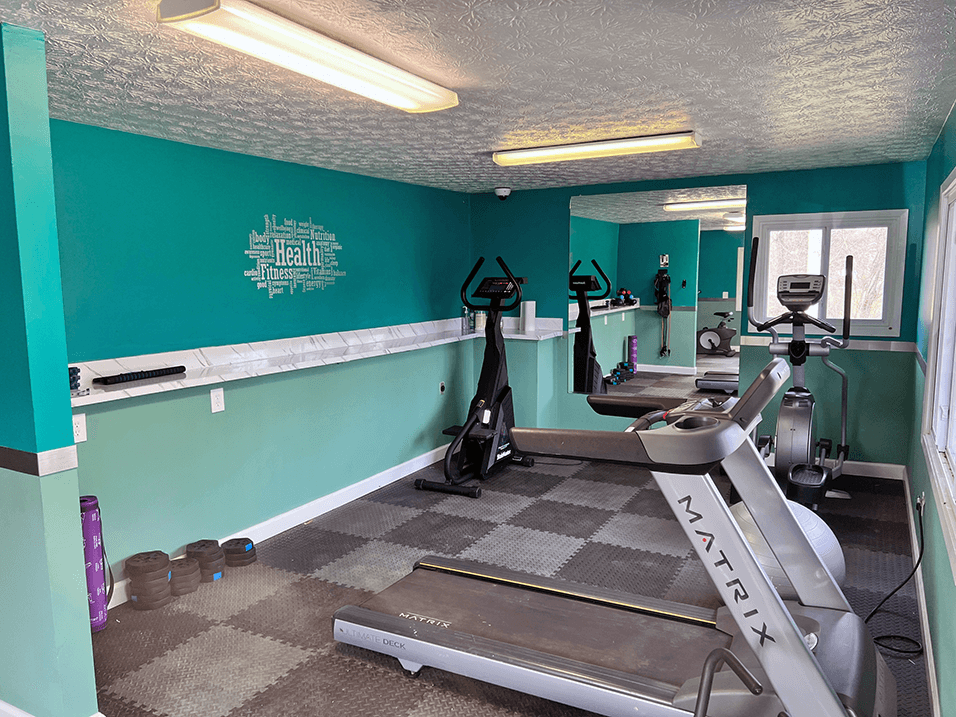 a gym with treadmills and other exercise equipment