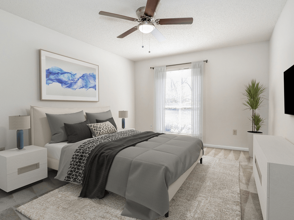 a bedroom with a bed and a ceiling fan