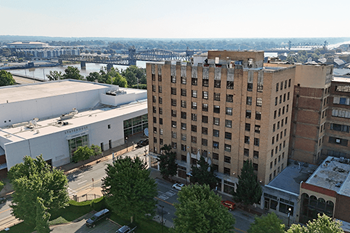A cityscape with a river and a bridge in the background.