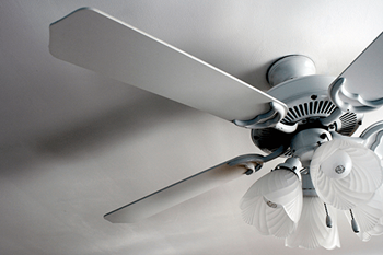 A white ceiling fan with five blades and a light fixture.