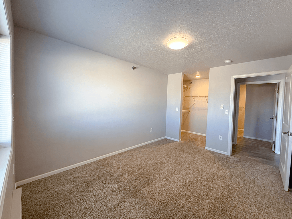 A room with carpeted floor and white walls.