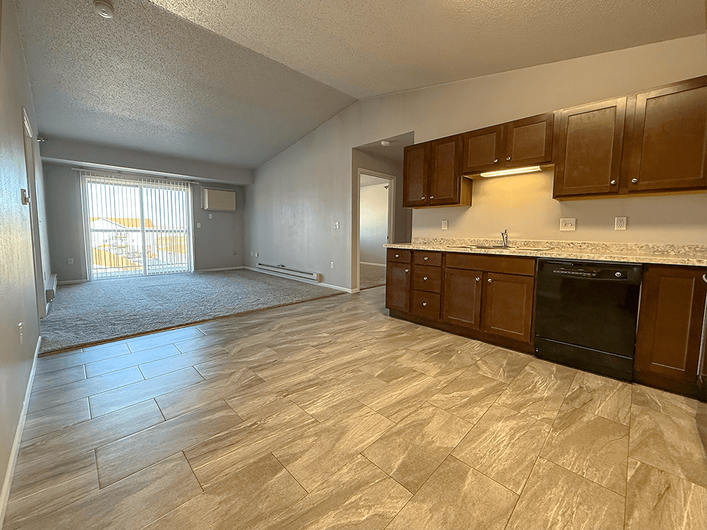 A kitchen with wooden cabinets and a black oven.
