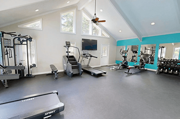 A spacious home gym with a variety of exercise equipment.