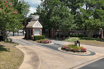 The entrance to Beacon Hill is marked by a sign and a small building.