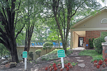 A sign in front of a building that says "Future Resident Parking".