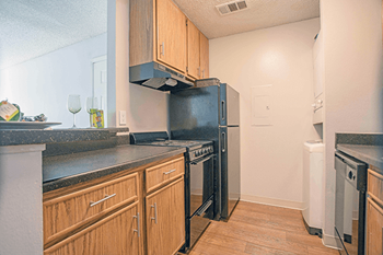 a kitchen with stainless steel appliances and wooden cabinets