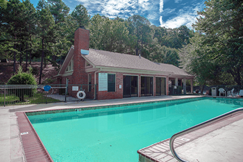 a house with a swimming pool in front of it