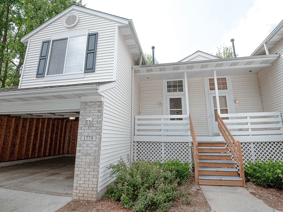 a white house with a brown garage door