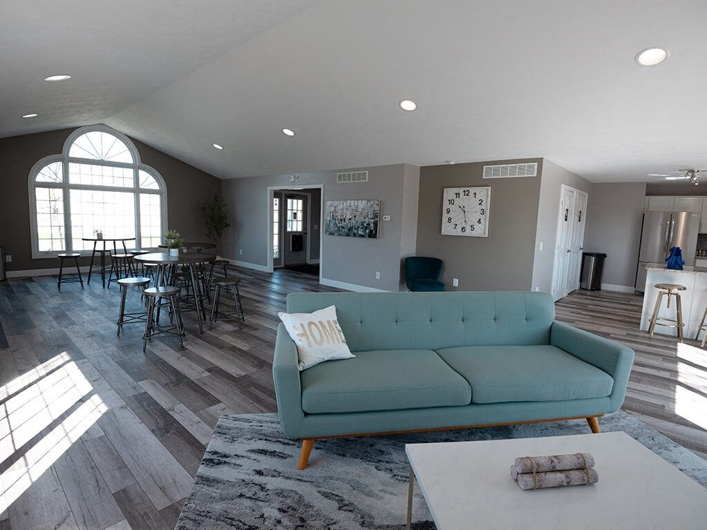 a living room with a couch and a table and chairs