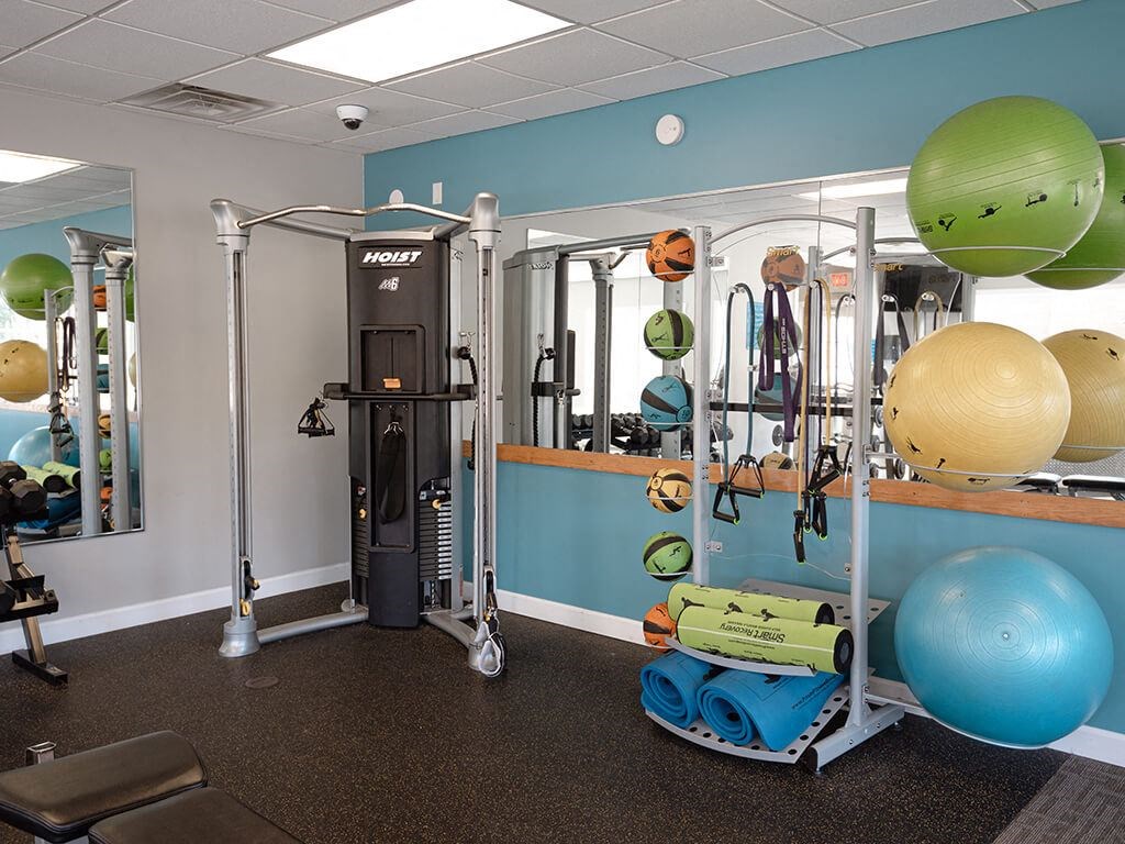 a gym with weights and equipment in a fitness room