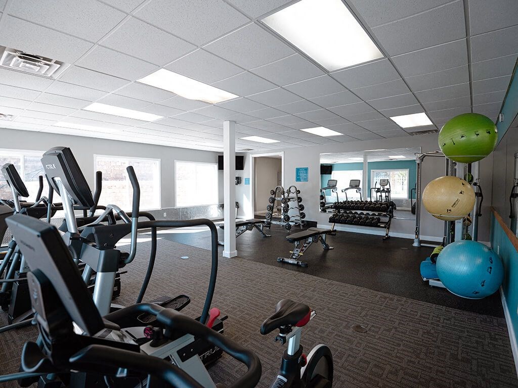a gym with weights and other exercise equipment in a workspace
