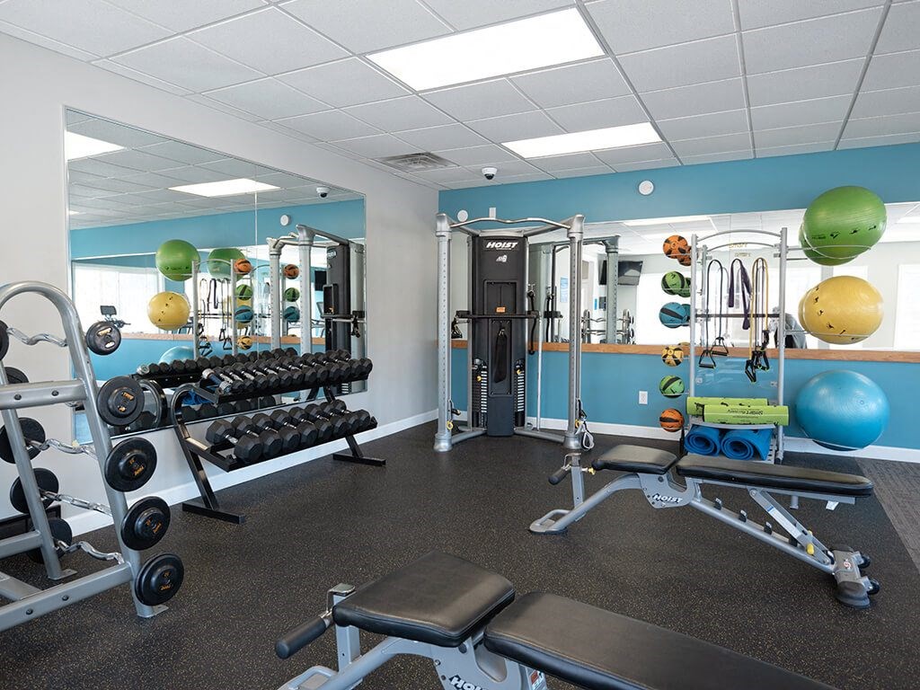 a gym with weights and other equipment in a room with blue walls