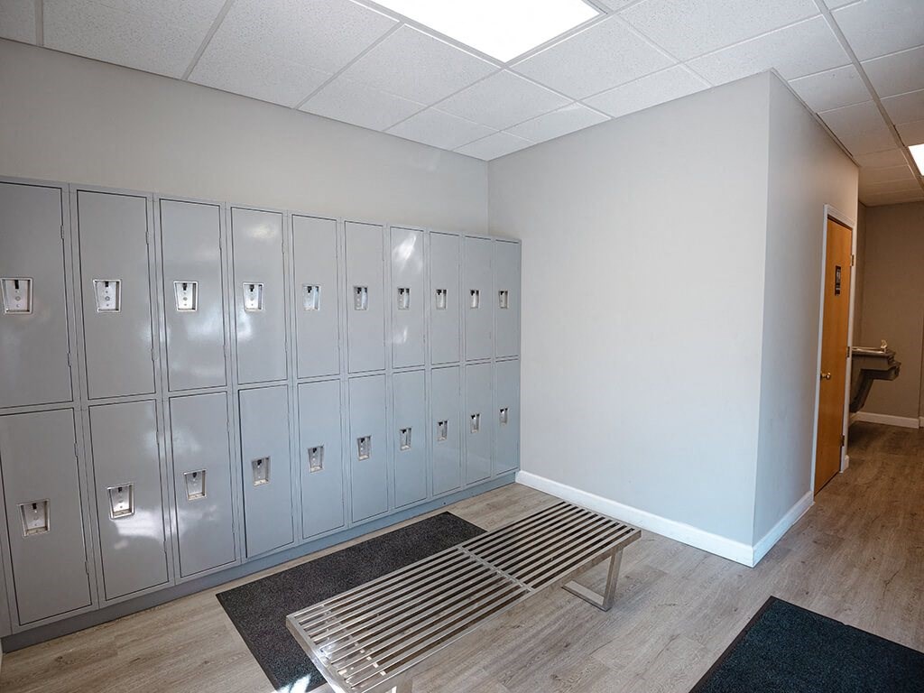 a row of lockers in a room with a bench