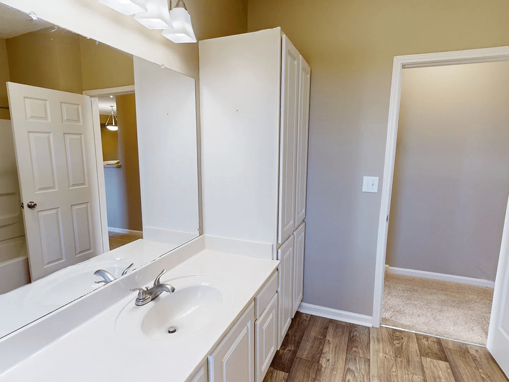 bright bathroom with a big mirror