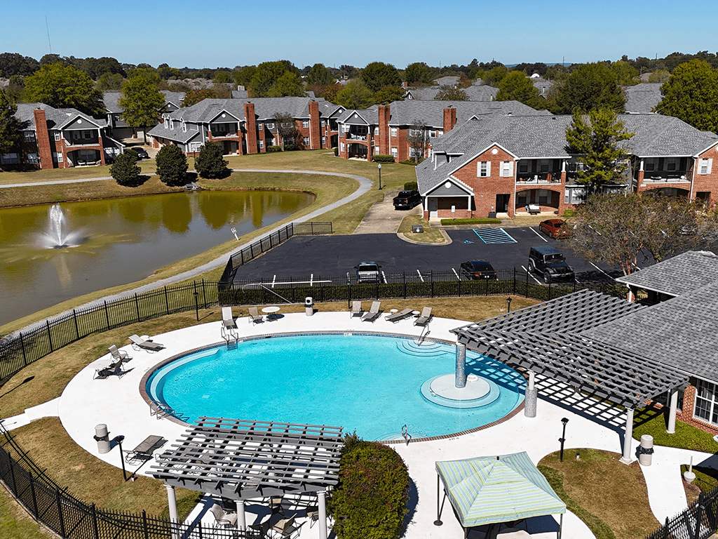 aerial view of an outdoor pool and pond