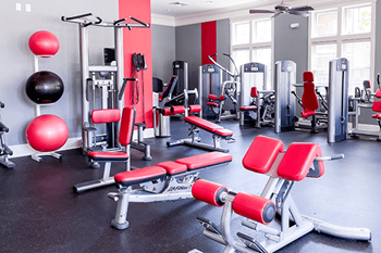 A gym with red and black equipment.