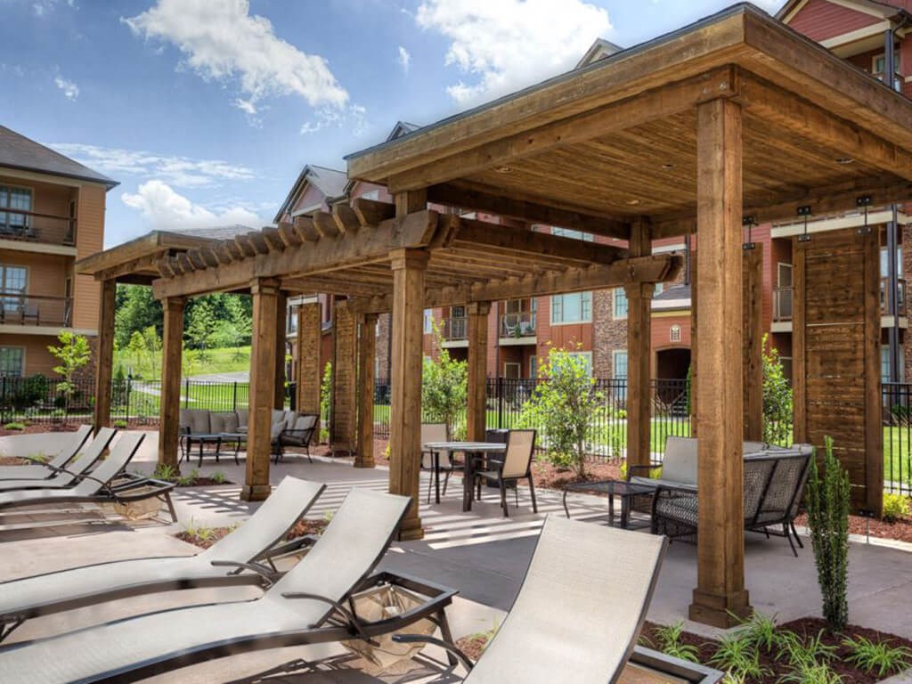 A wooden pergola with lounge chairs at Bluegrass Villas