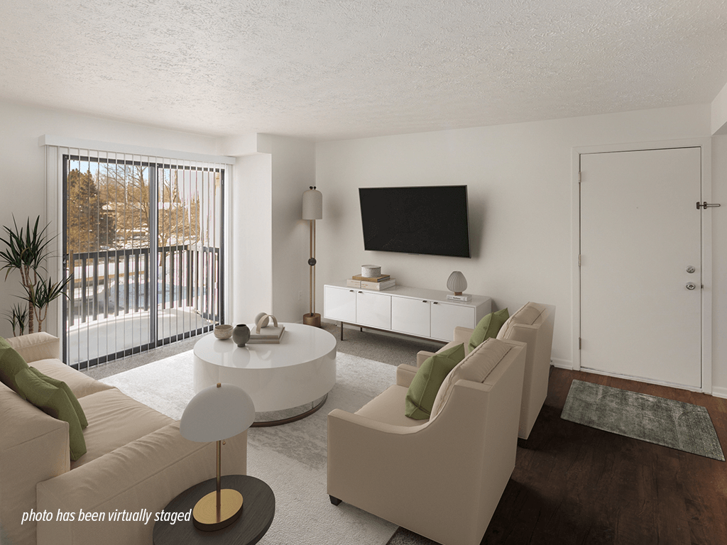 A modern living room with a flat screen TV mounted on the wall.