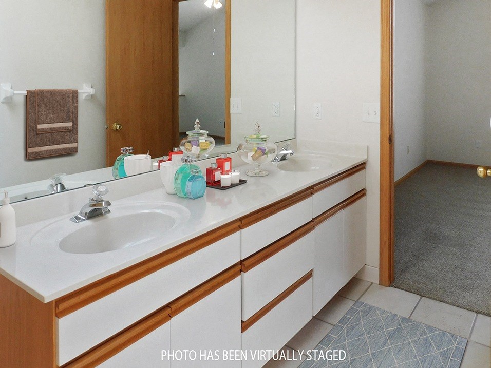 a bathroom with two sinks and a large mirror