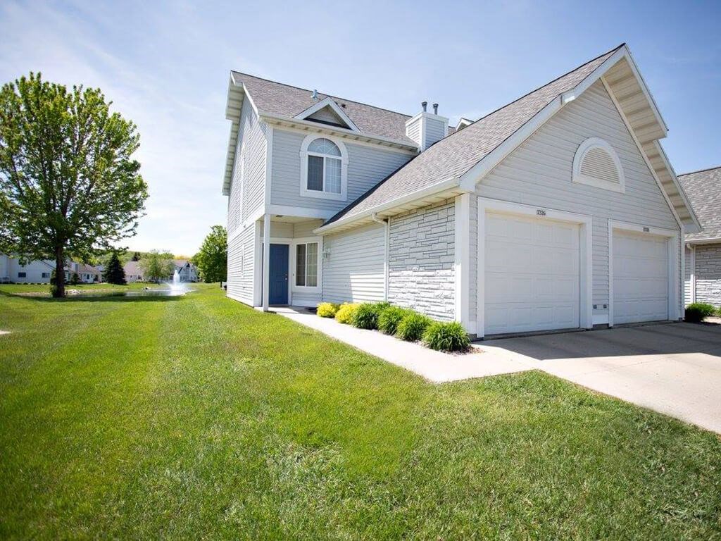 A two-story house with a garage on the right side.