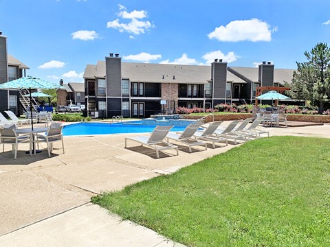 our apartments have a large pool with chairs and umbrellas