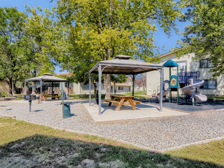 Beautiful covered picnic area by the apartment community playground. 