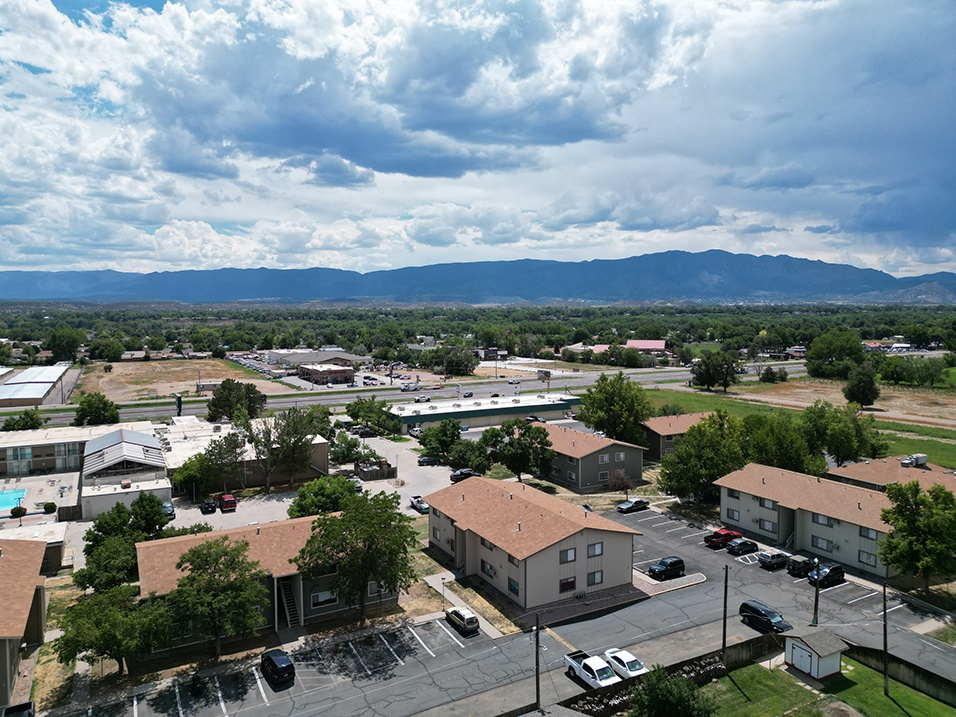 an aerial view of a city with mountains in the background