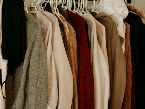 a rack of ties in a closet