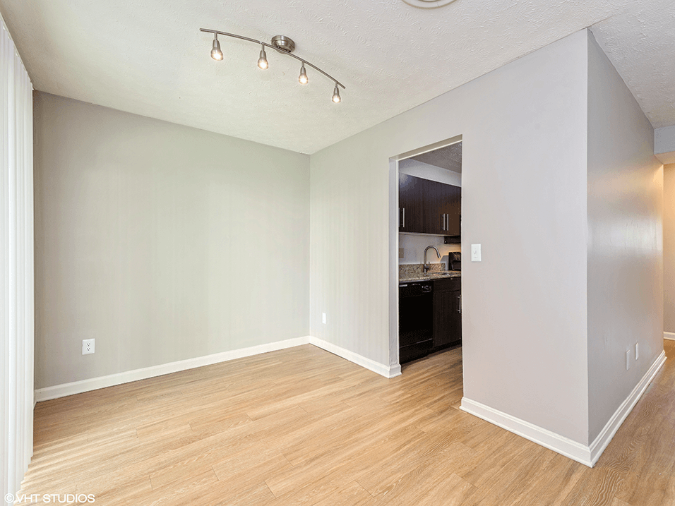 dining room with wood flooring and a kitchen