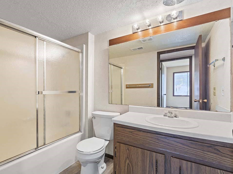 a bathroom with a sink toilet and shower