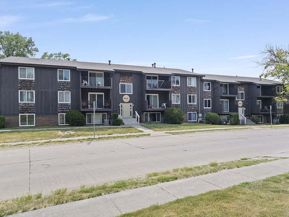 a large apartment building with a street in front of it