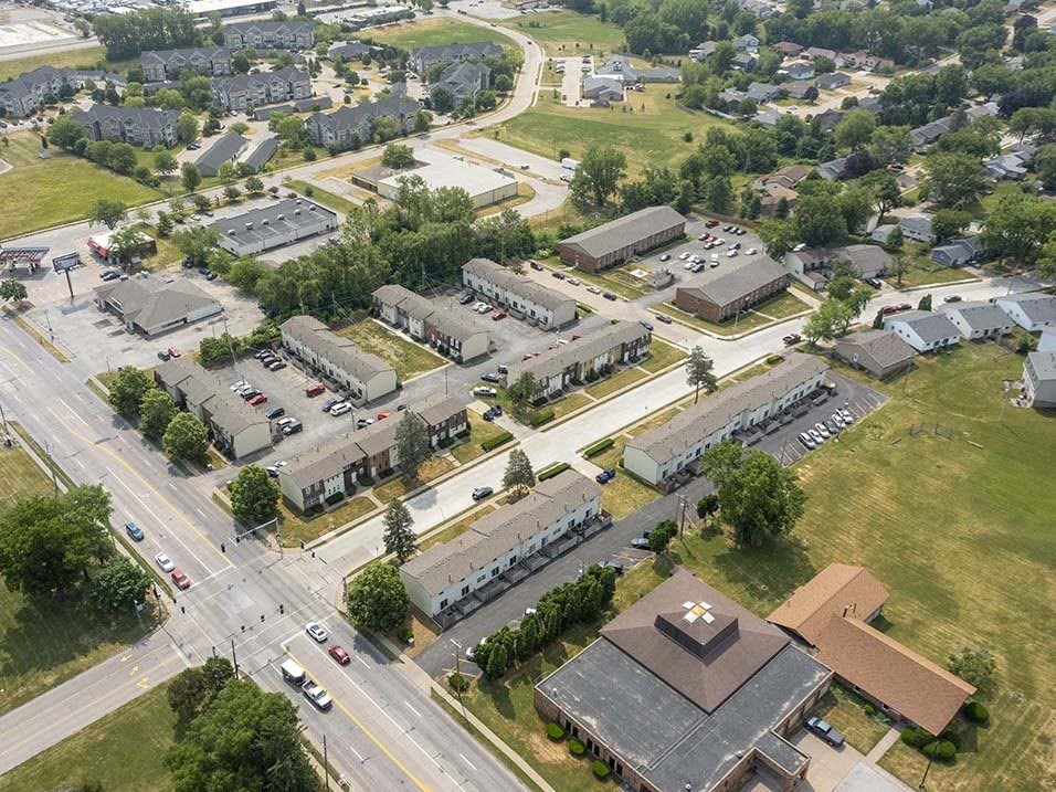 an aerial view of a city with several buildings and a parking lot