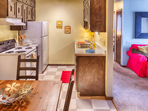a kitchen with a table and a stove and a refrigerator