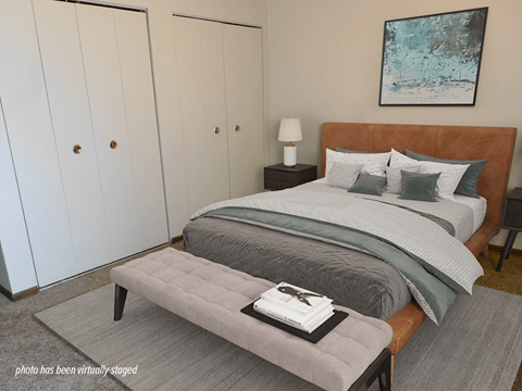 A bedroom with a large bed and a painting on the wall.