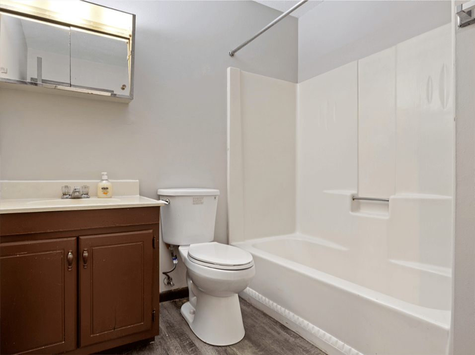 bathroom with a toilet and a shower tub