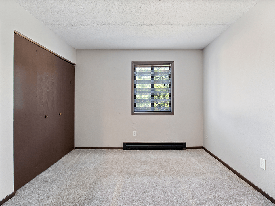 bedroom with a window and a closet