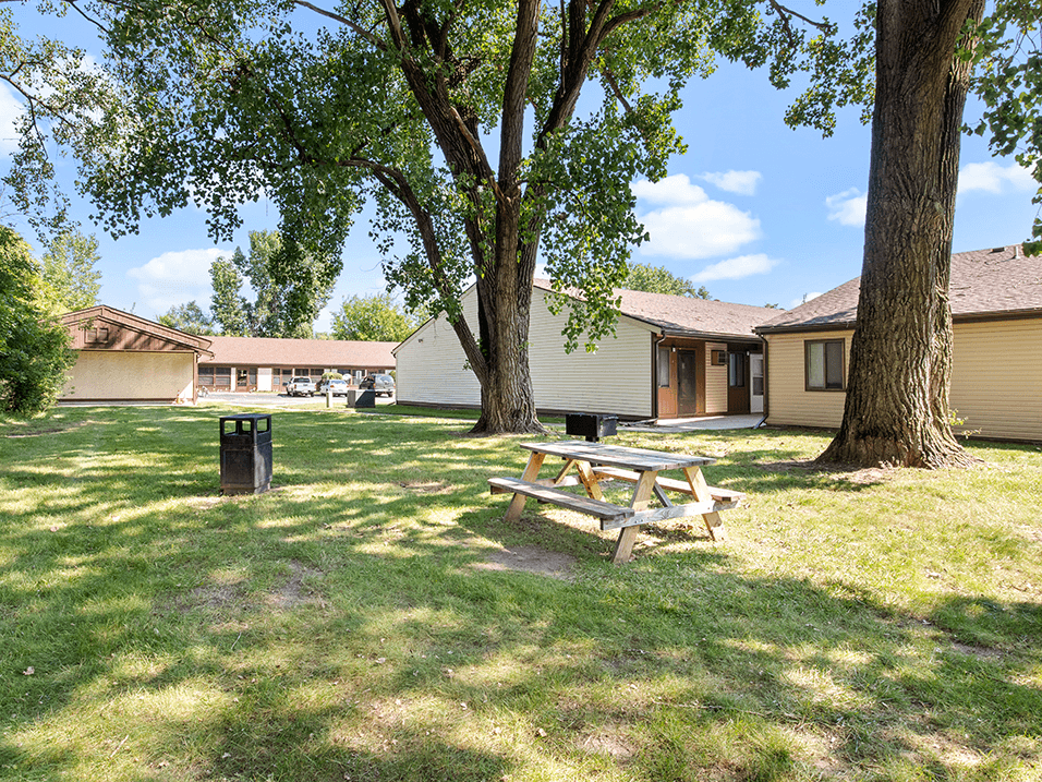 a picnic table in a courtyard next to an apartment building