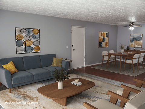 A living room with a blue couch and a coffee table.