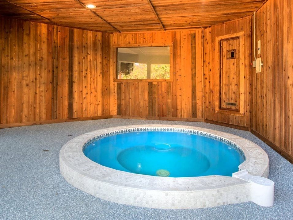 a jacuzzi in a cabin with a pool